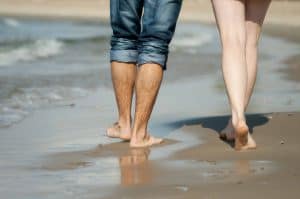 Legs of couple on the beach