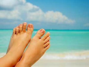 bare feet on a tropical beach.